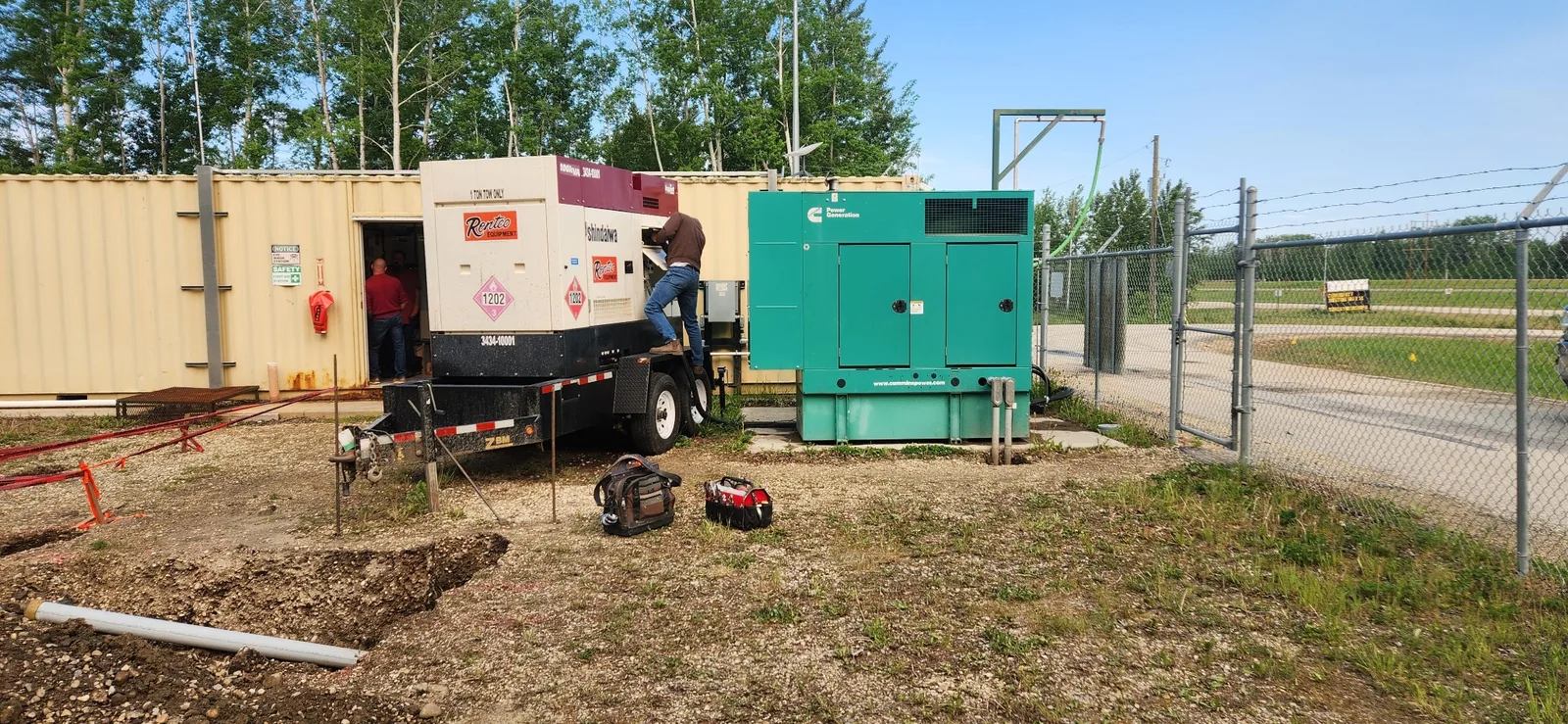 Electricians working on a commercial backup generator installation