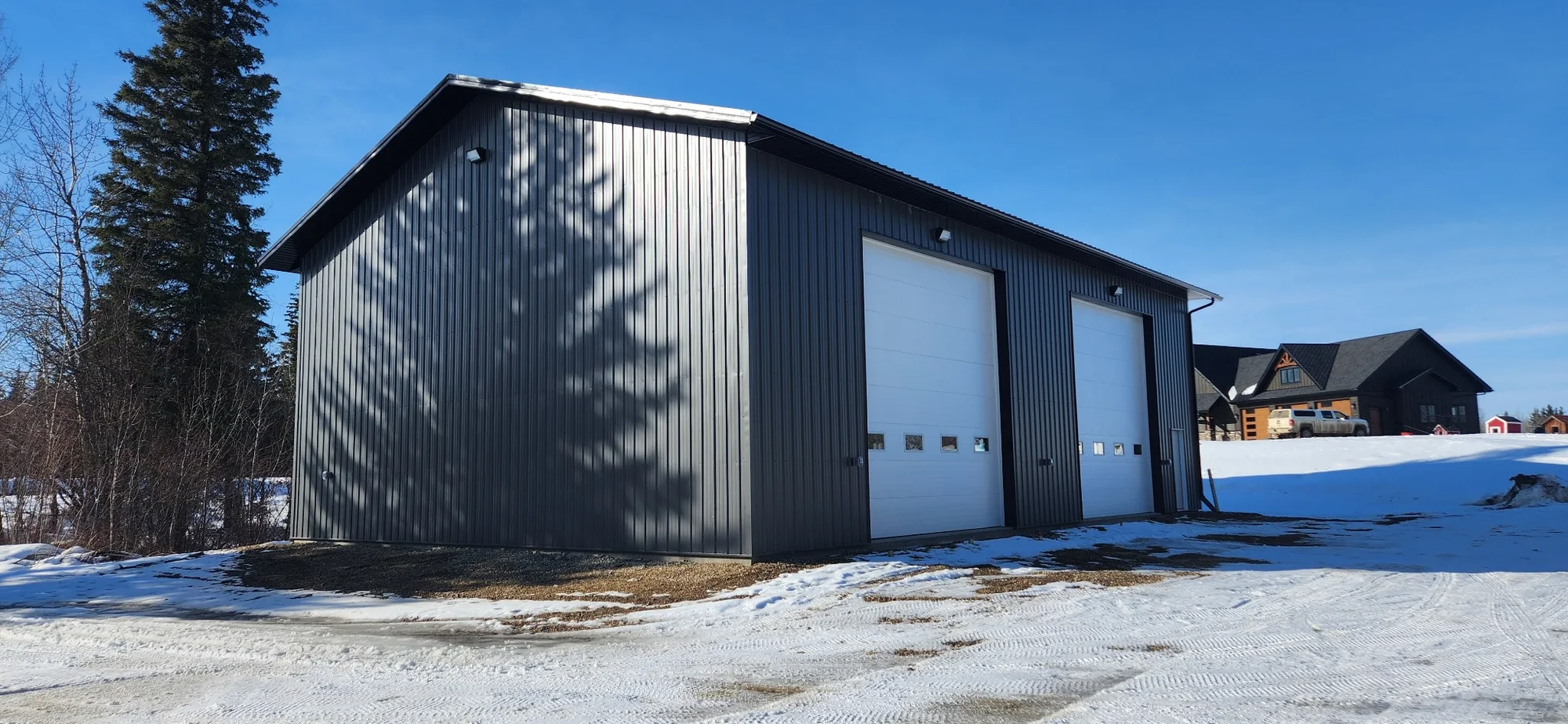 Completed rural shop with overhead doors and exterior lighting