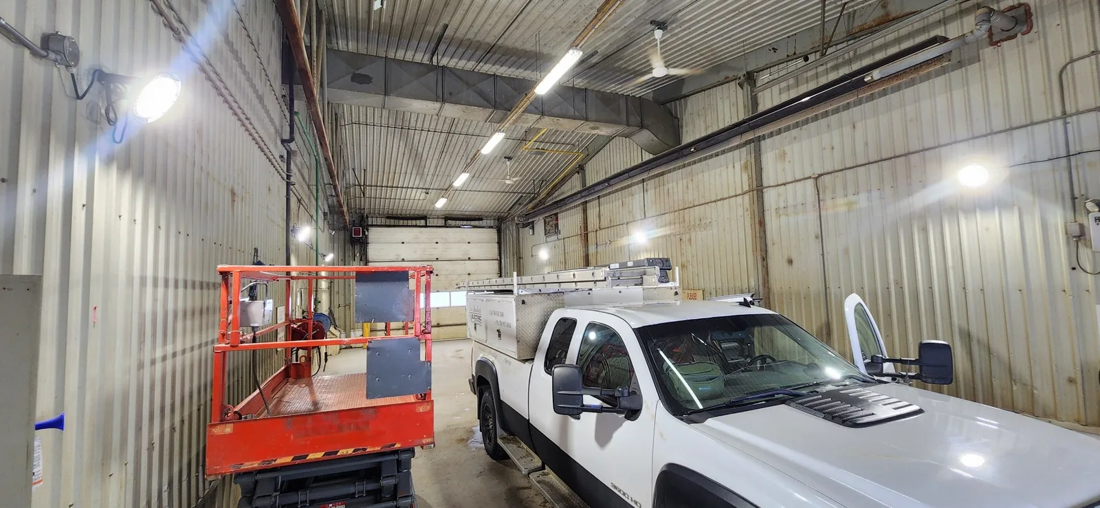 Dr. Sparkie's Electric truck inside an existing commercial shop during lighting work