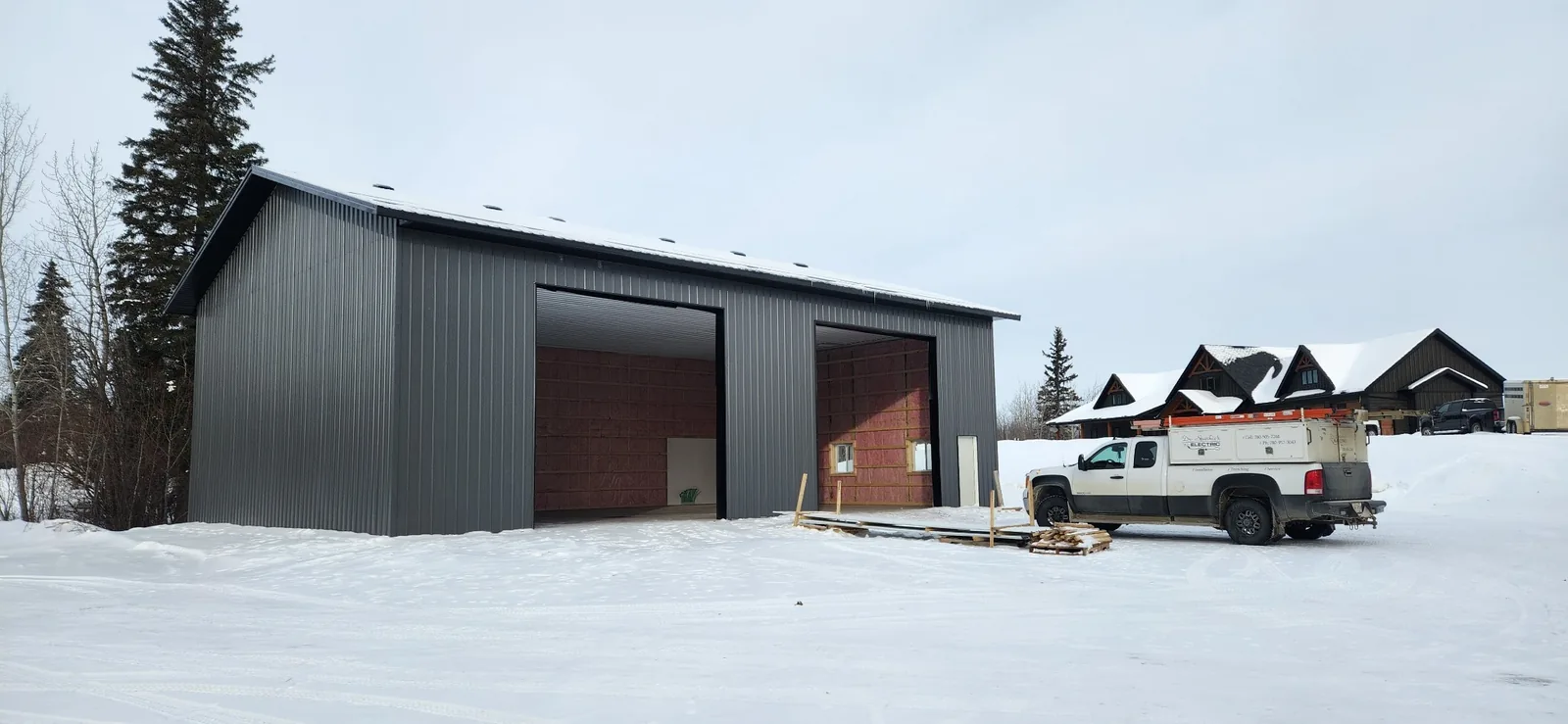 Rural shop under construction with Dr. Sparkie's Electric service truck